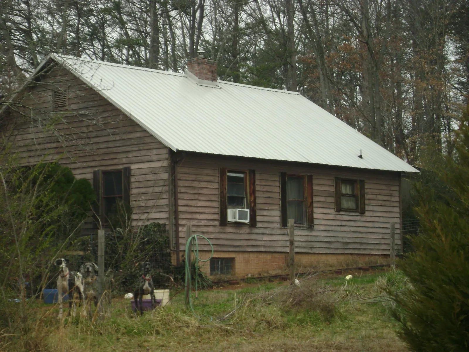 White metal roof on an old wood sided farmhouse, from a Metal Roof Installation job in Fort Mill